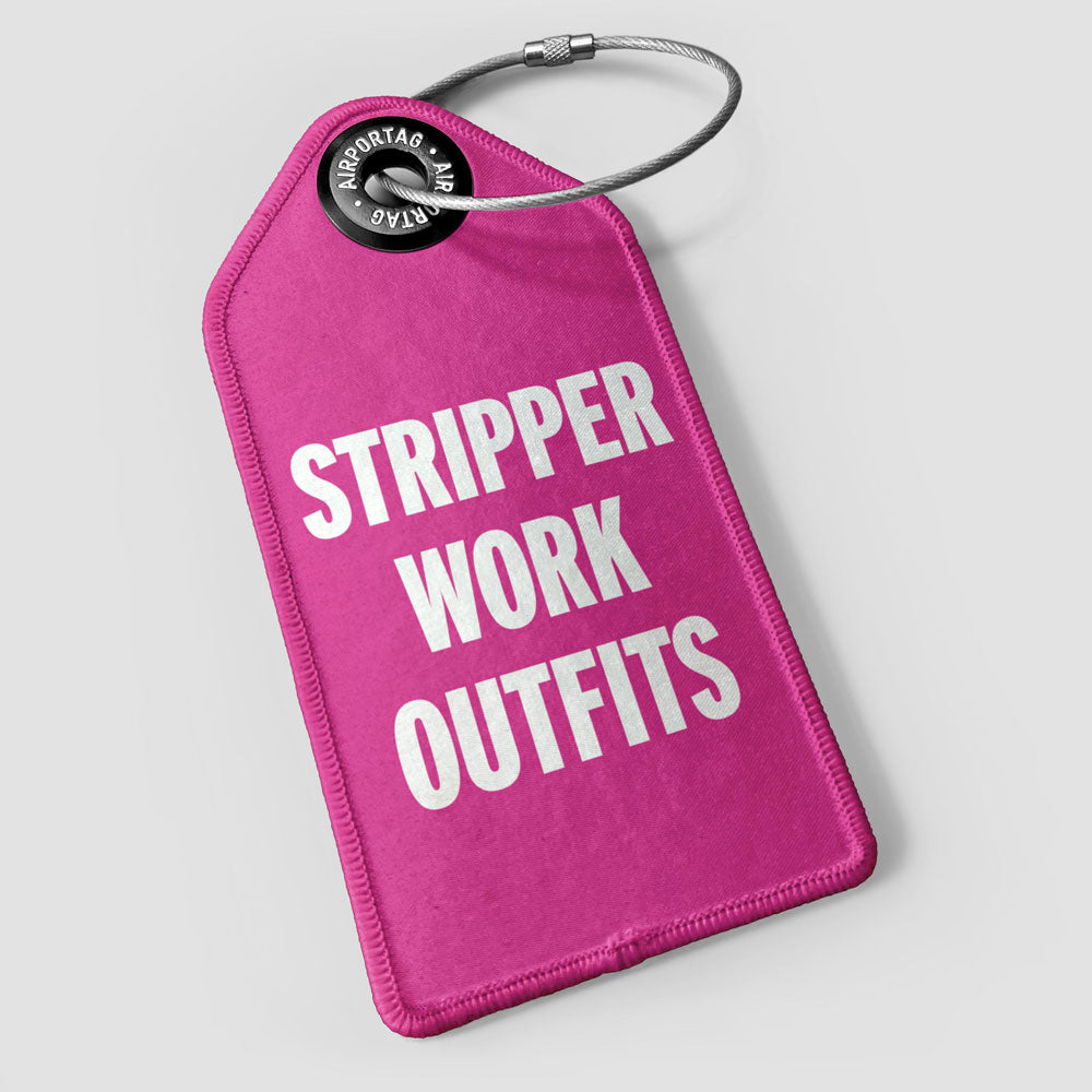 A pink rectangular luggage tag with the words 'STRIPPER WORK OUTFITS' printed in white. It has a black loop for attaching to luggage.