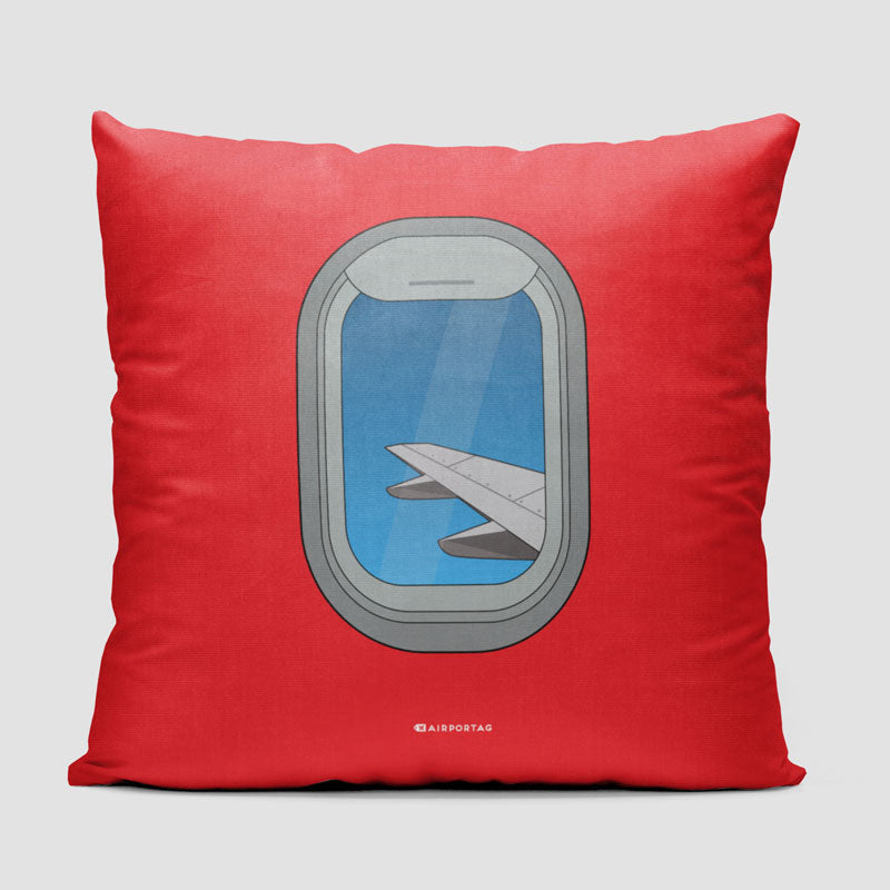 飛行機の窓 - 枕を投げる
