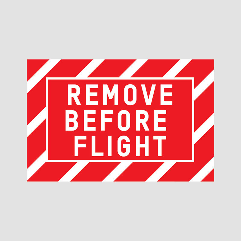 Fo your safety please remove before flight. Aviation & airplane detail - remove  before flight ribbon in a door. Stock Photo